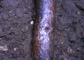 This photograph shows a corroded steel underground oil line: